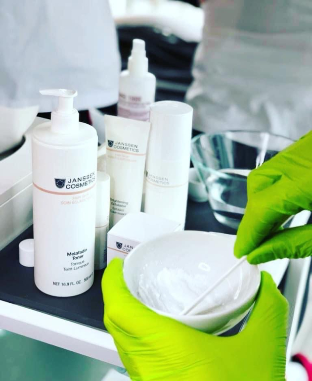 Professional skincare products used during cosmetology training and facial treatment education.