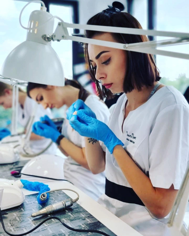 Professional electric nail file training for nail preparation and manicure techniques.