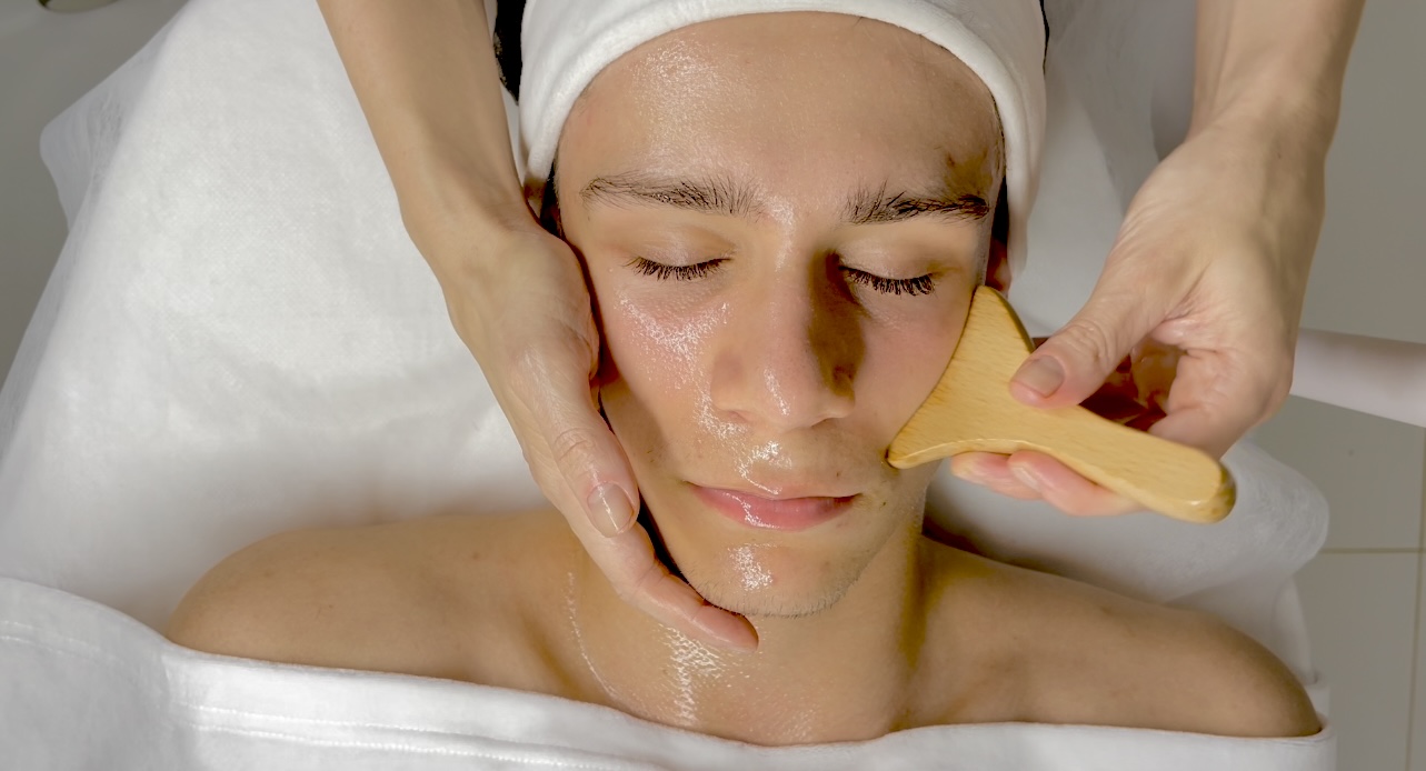 Wood therapy (maderotherapy) facial massage using wooden tools – lifting technique performed as part of a professional beauty course.
